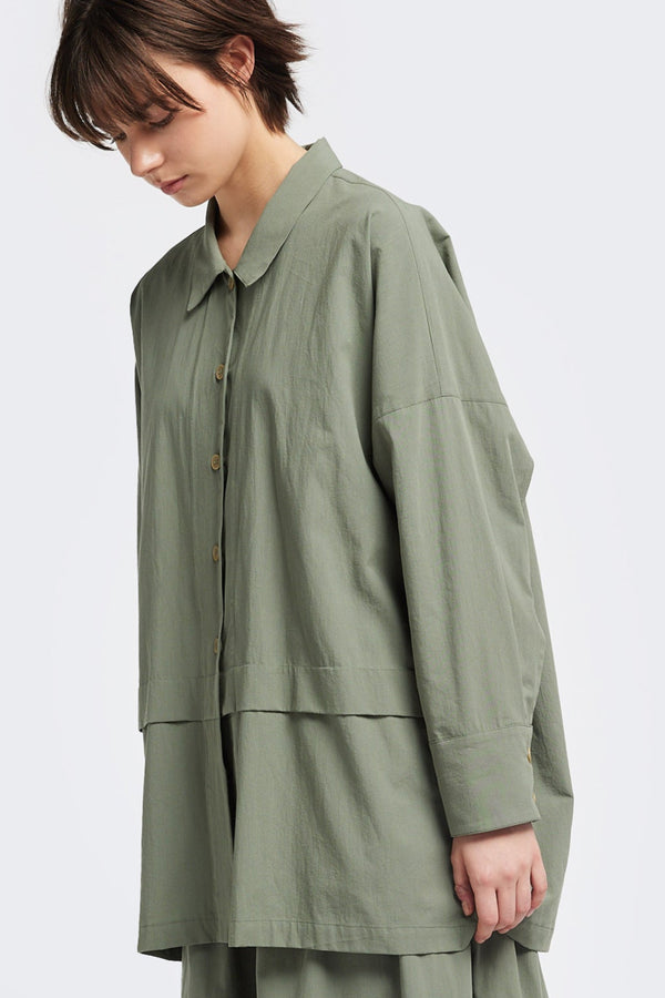 Front of the Plein Long Sleeve Shirt in Olive Green. An oversized panel shirt with a cocoon back, front tuck, and pleated dropped sleeves, can be styled as a lightweight jacket.