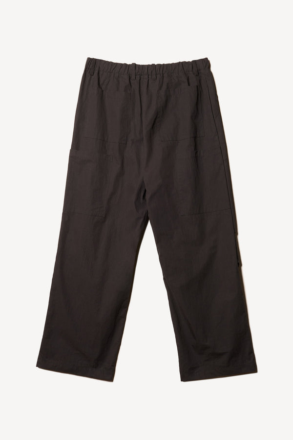 Flat Back of the Premise Cargo in Jet Black, a relaxed-fit pant with adjustable waistband, clean front pleats, and straight-leg silhouette.