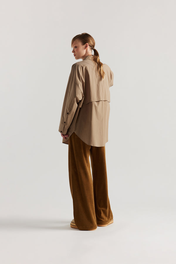 Back view of slouchy track pants in coffee brown cotton terry with straight-leg fit and cord-tie waistband.