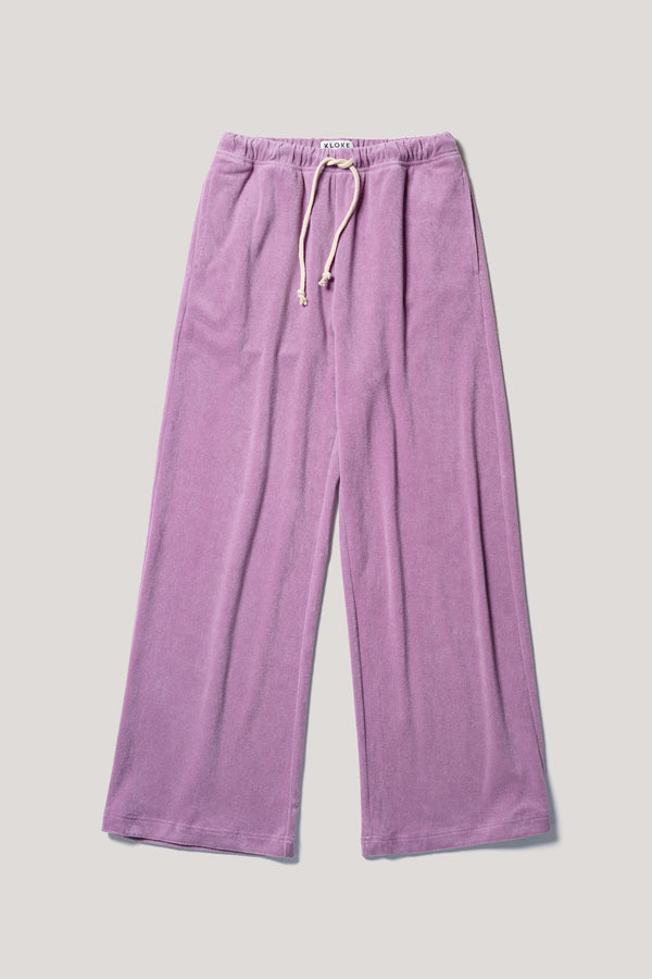Flat front of slouchy track pants in purple cotton terry with straight-leg fit and cord-tie waistband.