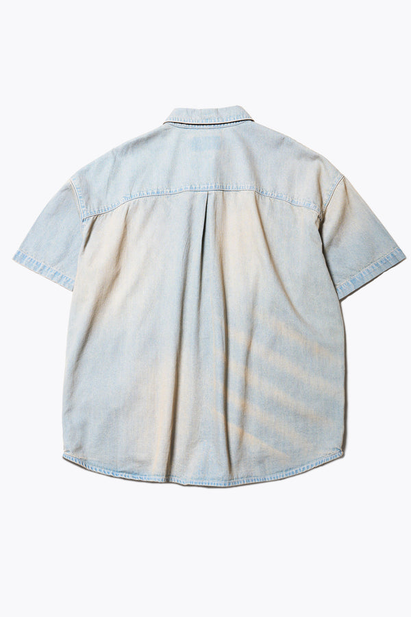 Flat back of the Province Oversized short-sleeve denim shirt with feature front scoop pockets, in a blue fade with a slight pink tint. Available in 5 sizes. 