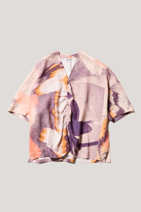 Flat front of the Psyche Top, a  relaxed linen V-neck top in the Kloke Chaos print with gathered centre-front detail.