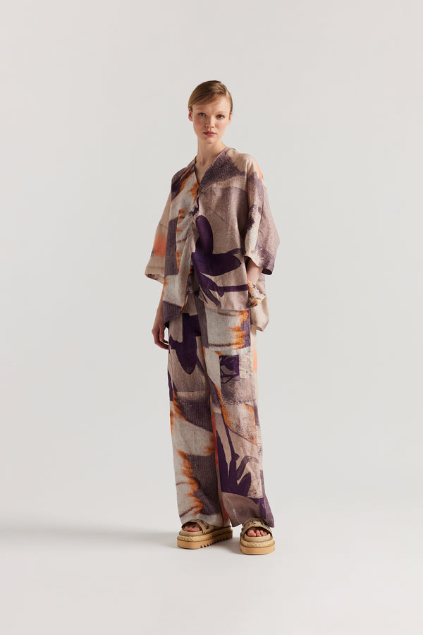 Front view of Model wearing the Psyche Top, a  relaxed linen V-neck top in the Kloke developed Chaos print with gathered centre-front detail.