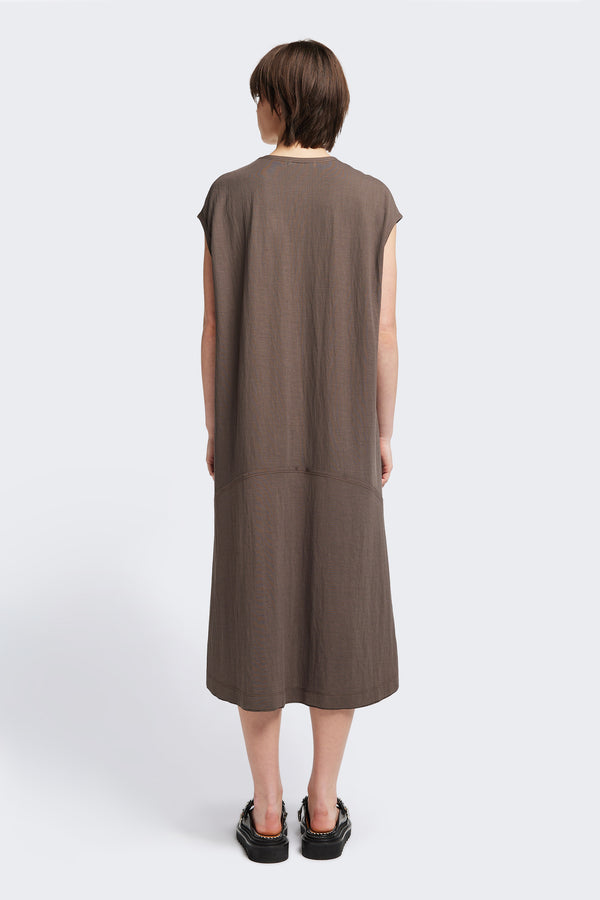 Back of the Recess dress in taupe, a sleeveless crew-neck midi dress with exposed seams, raw-edge finish, and a relaxed silhouette that falls just below the knees, offering a versatile look for casual or elevated occasions.