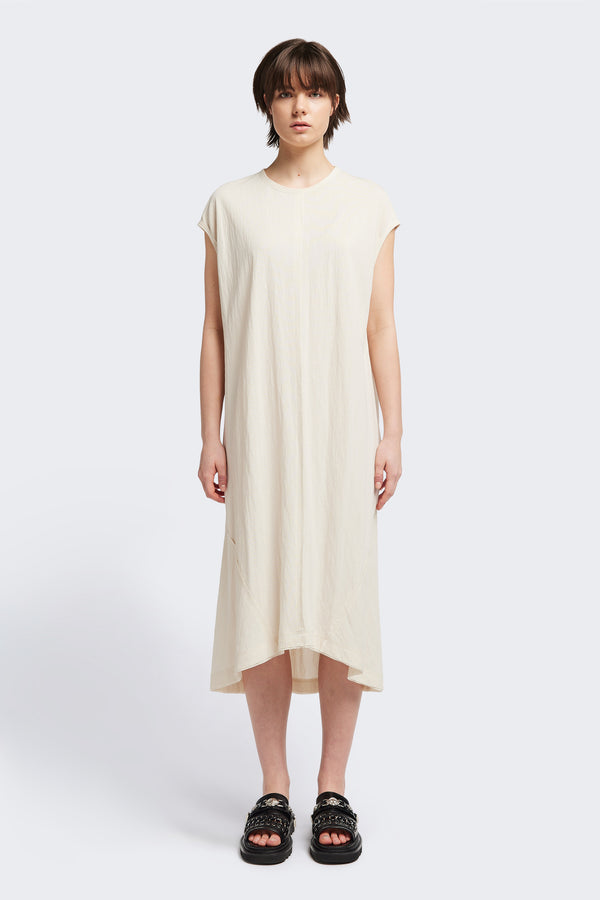 Front of the Recess dress in ecru, a sleeveless crew-neck midi dress with exposed seams, raw-edge finish, and a relaxed silhouette that falls just below the knees, offering a versatile look for casual or elevated occasions.