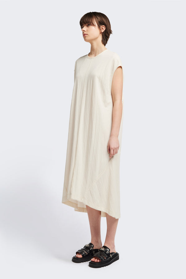 Front of the Recess dress in ecru, a sleeveless crew-neck midi dress with exposed seams, raw-edge finish, and a relaxed silhouette that falls just below the knees, offering a versatile look for casual or elevated occasions.