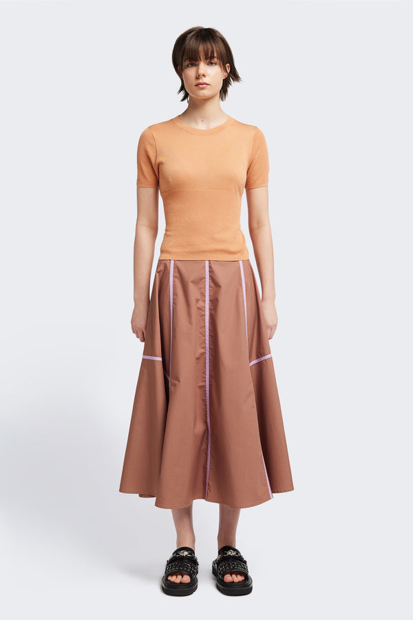 front of the brown/lilac Regarder Bound Skirt in a lightweight cotton fabric, featuring a fuller silhouette with contrast bound seam details, midi length, and a back invisible zip closure.