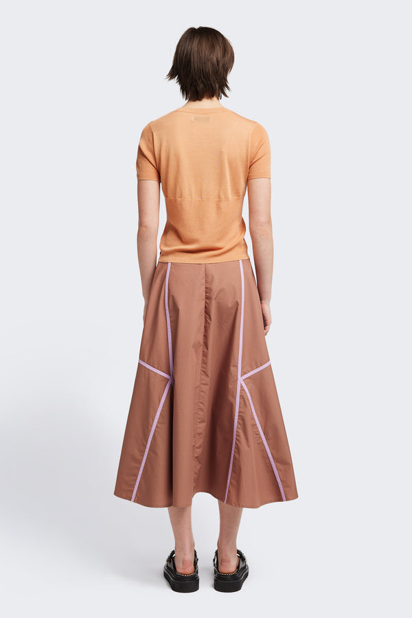 back of the brown/lilac Regarder Bound Skirt in a lightweight cotton fabric, featuring a fuller silhouette with contrast bound seam details, midi length, and a back invisible zip closure.