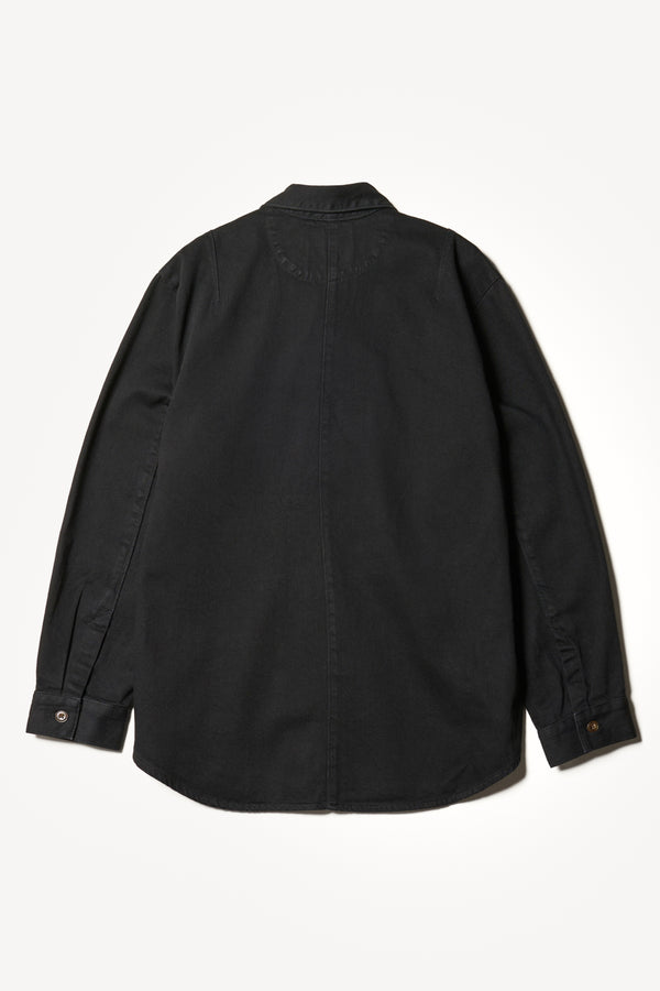 Flat back shot of the Region oversized denim shirt in Black, featuring utility chest pockets