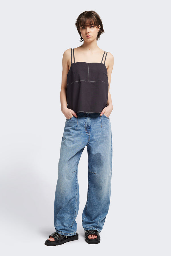 Front view of model in the the Reset Jean, a darted relaxed baggy jean - in mid blue fade