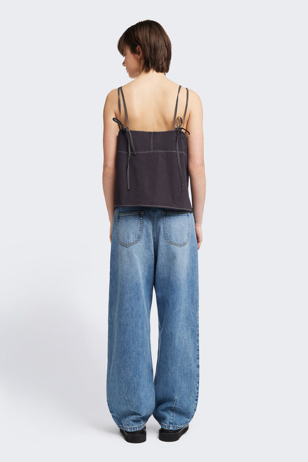 Back view of model in the the Reset Jean, a darted relaxed baggy jean - in mid blue fade