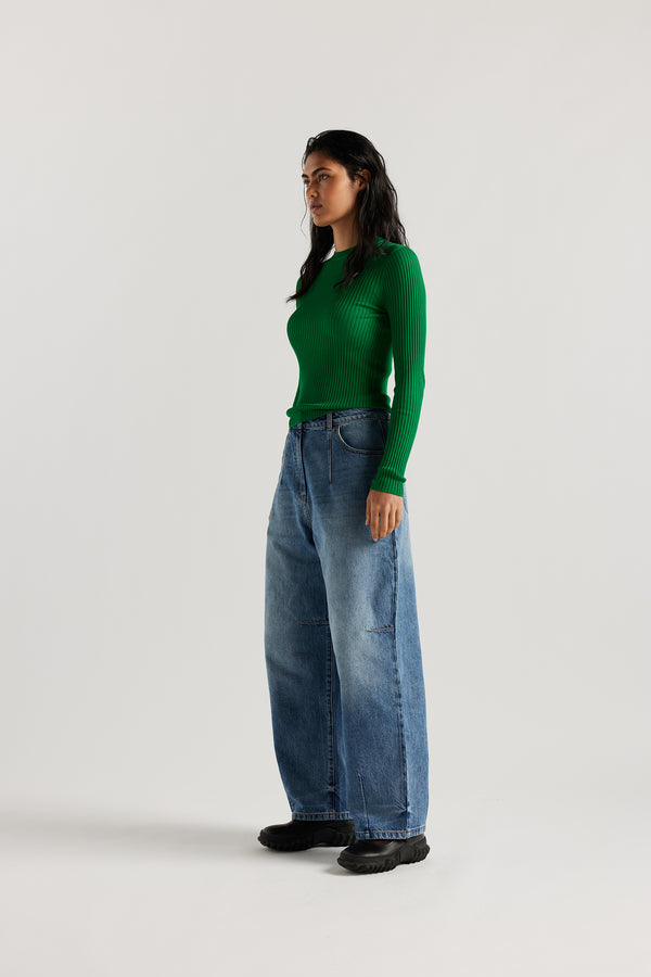 Front view of model in the the Reset Jean, a darted relaxed baggy jean - in mid blue fade