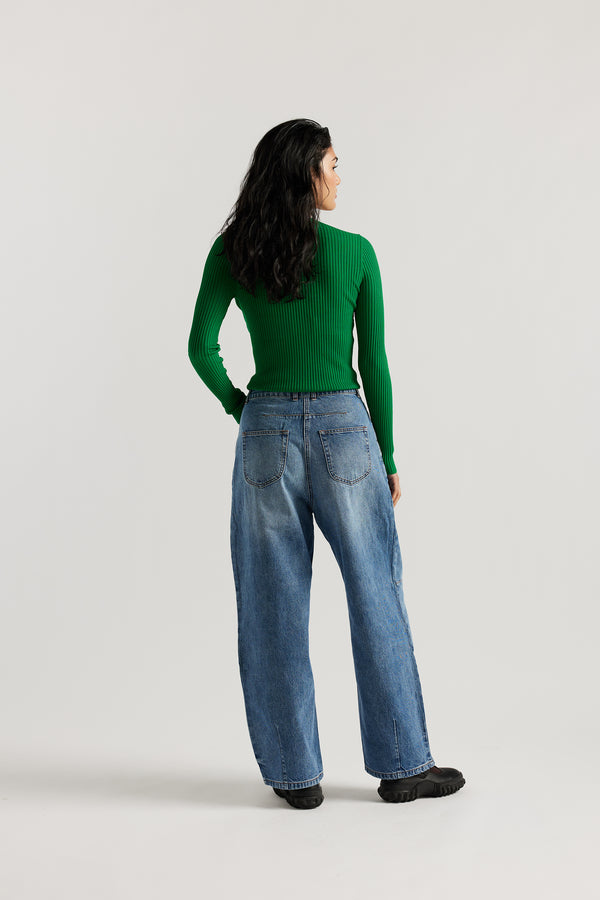 Back view of model in the the Reset Jean, a darted relaxed baggy jean - in mid blue fade