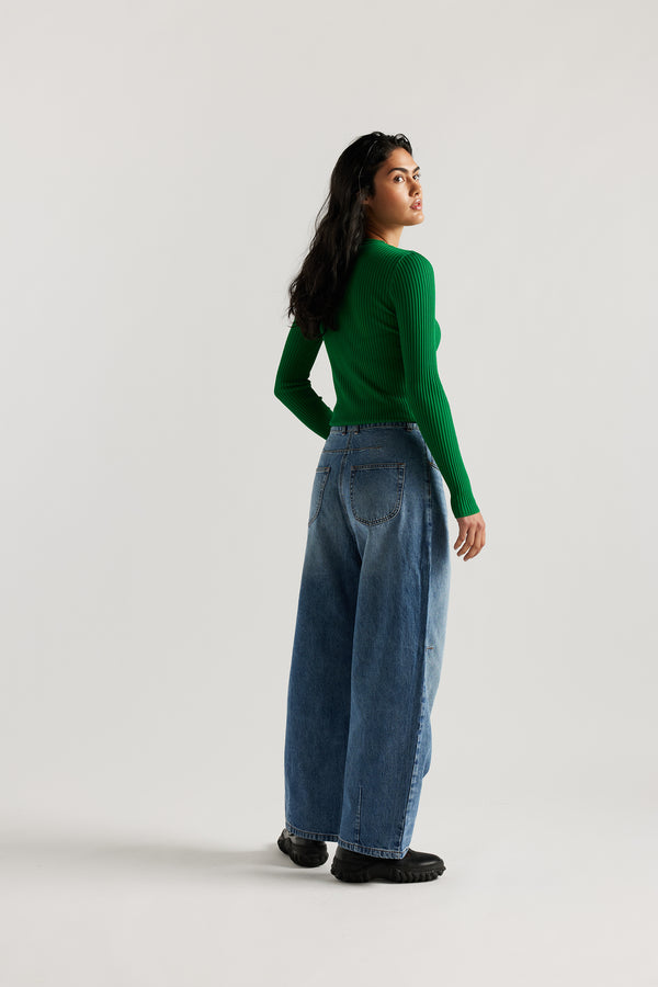 Back view of model in the the Reset Jean, a darted relaxed baggy jean - in mid blue fade