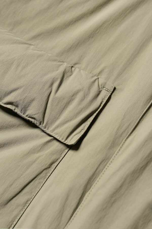 Close-up detail shot of fabric and pocket on the Restore Coat in Dusty Olive Green

