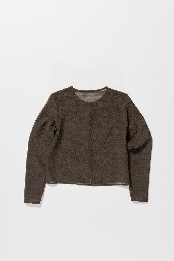 Flat back of the Rising LS Shirt in Brown. A slim-fitting long sleeve shirt with rounded self-bind collar and straight hem.