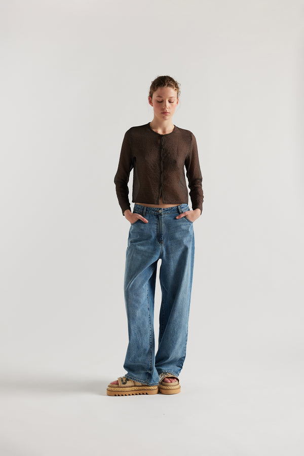 Front View of model in the Rising LS Shirt in Brown. A slim-fitting long sleeve shirt with rounded self-bind collar and straight hem.