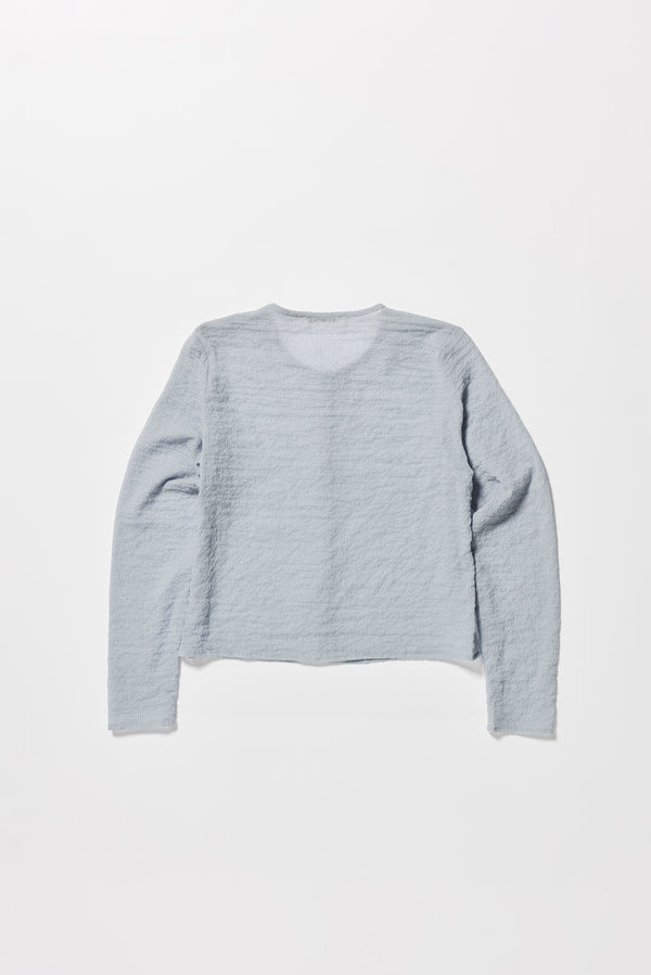 Flat Front of the Rising LS Shirt in Pale Blue. A slim-fitting long sleeve shirt with rounded self-bind collar and straight hem.