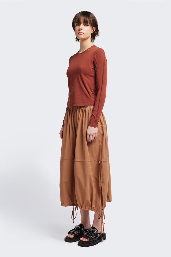 Front view of the Seclude long sleeve top in Brick. A Slim-fit crew neck top in soft cotton stretch, featuring an exposed bound seam curving across the back and sleeves.