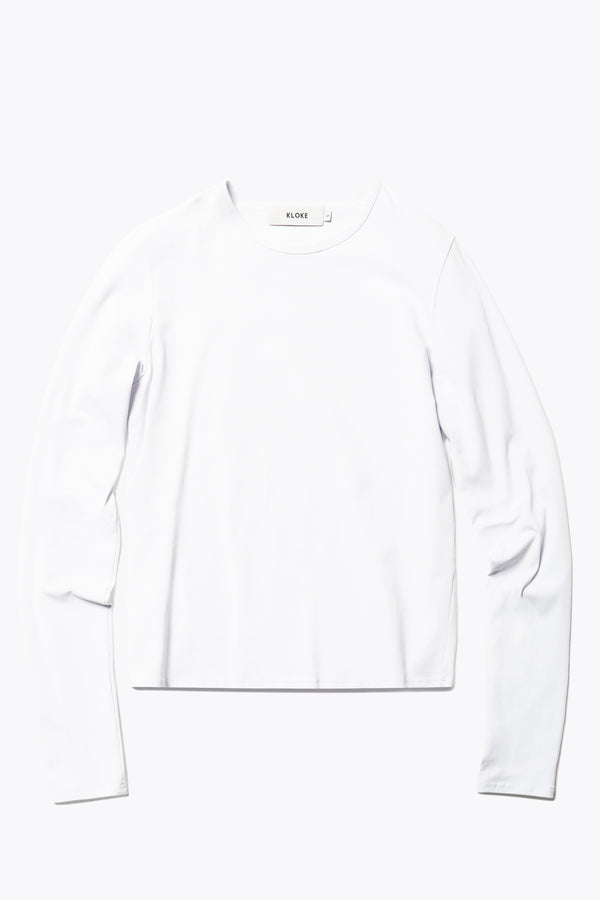 Flat Front view of the Seclude long sleeve top in ice blue. A Slim-fit crew neck top in soft cotton stretch, featuring an exposed bound seam curving across the back and sleeves.