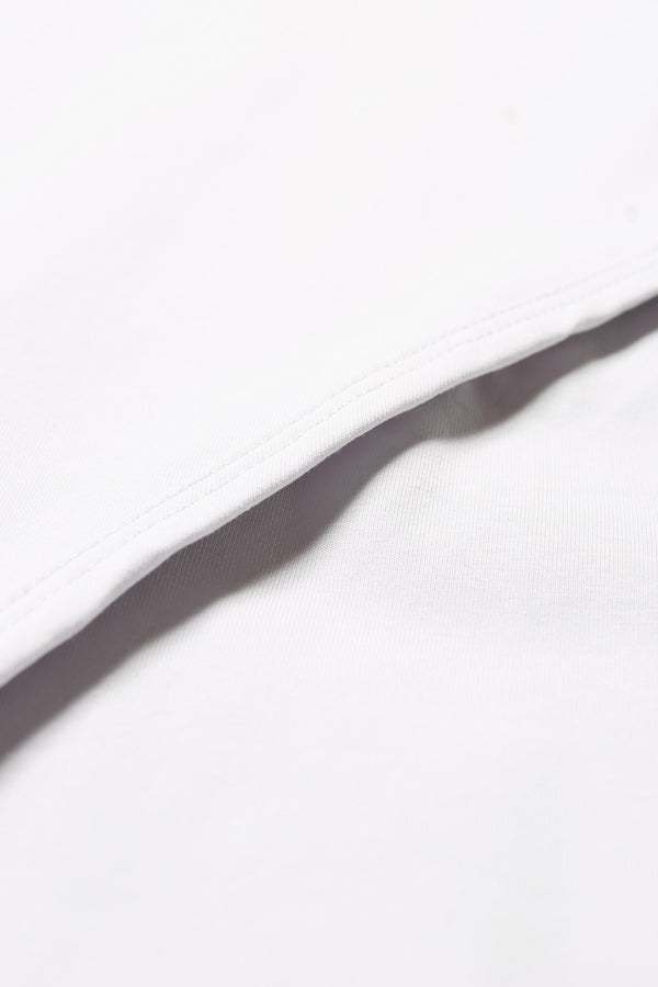 Close up details of the Seclude long sleeve top in ice blue. A Slim-fit crew neck top in soft cotton stretch, featuring an exposed bound seam curving across the back and sleeves.