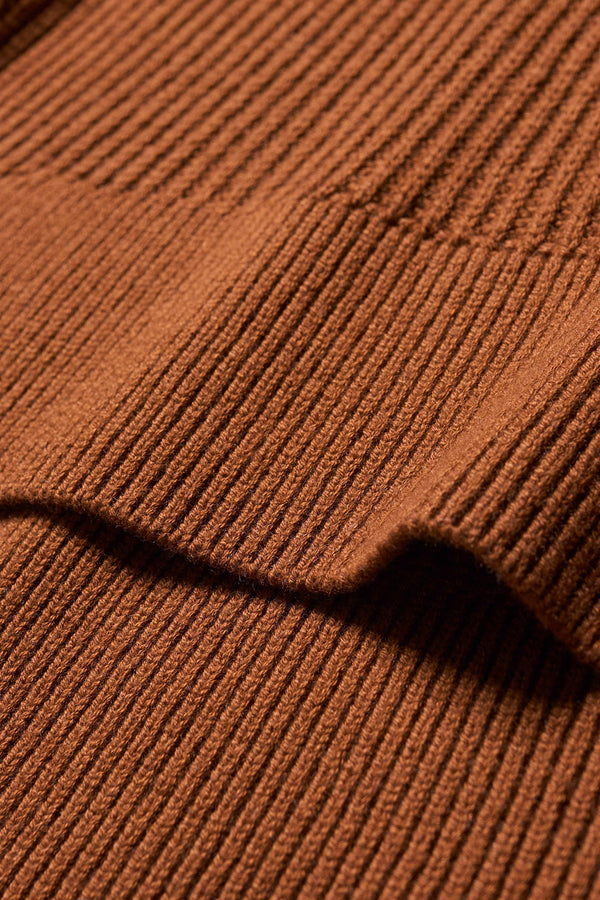 Close up fabric detail shot of toffee brown sleeveless ribbed knit vest with side ties in merino and cotton blend