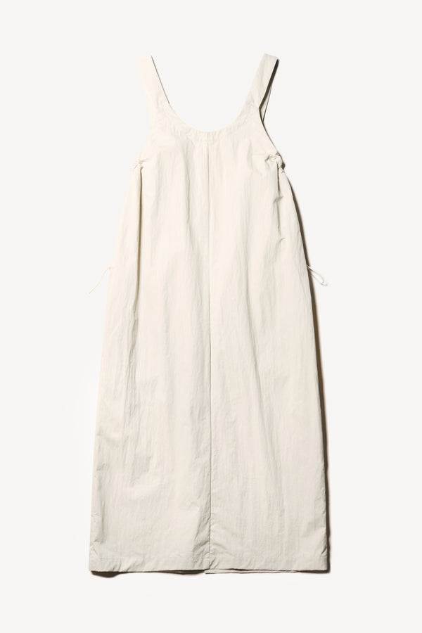 Flat back of the Shoreline full-length pinafore dress in bone white with deep round neckline and front patch pockets, a relaxed-fit silhouette. 