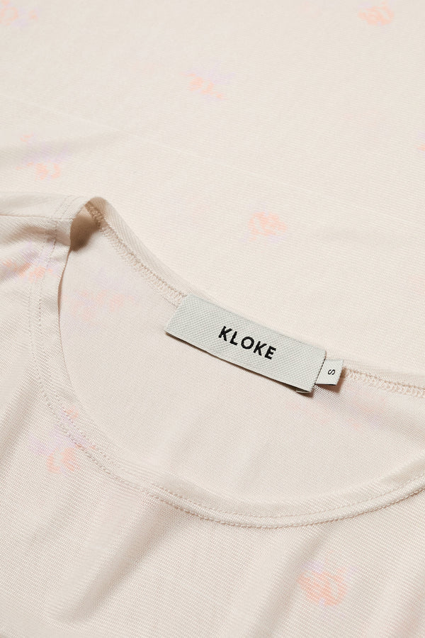 Close up fabric shot of the Spring Mesh Long Sleeve Top featuring a delicate floral print on lightweight, sheer mesh fabric. Ideal for layering under dresses or shirts. Available in 6 sizes. 