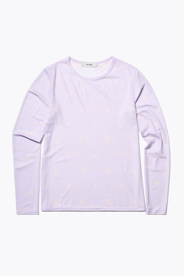 The Spring Mesh Long Sleeve Top in lilac floral, featuring a delicate floral print on lightweight, sheer mesh fabric. Ideal for layering under dresses or shirts. Available in 6 sizes. 
