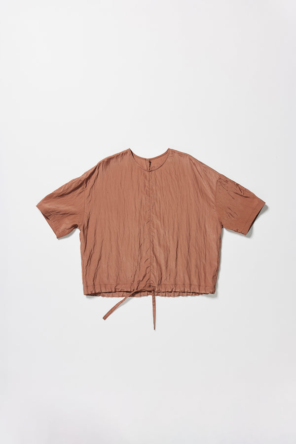 Flat front of the Cocoa brown Stillness Top with round neckline and centre front seam detail.