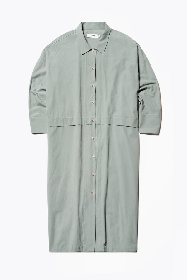 Flat Front view of the Sundown Shirt Dress in Olive Green, a relaxed-fit, knee-length shirt dress with a cocooned back and front tuck detail.