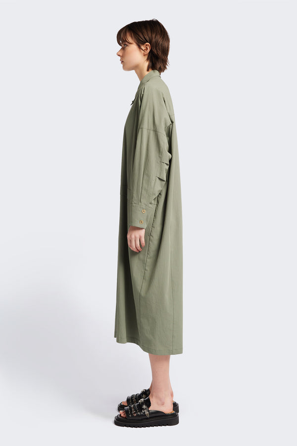 Side view of the Sundown Shirt Dress in Olive Green, a relaxed-fit, knee-length shirt dress with a cocooned back and front tuck detail.