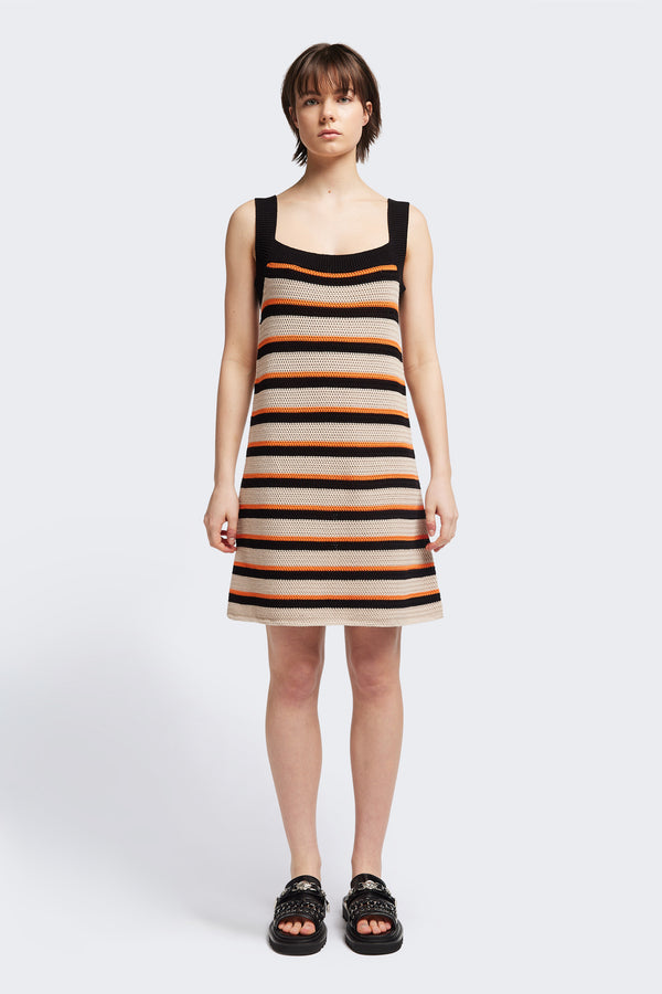 Front of The Temporal Dress in soft cotton yarn with shallow knit stripes in black, orange, and mushroom, featuring wide straps and a straight black neckline.