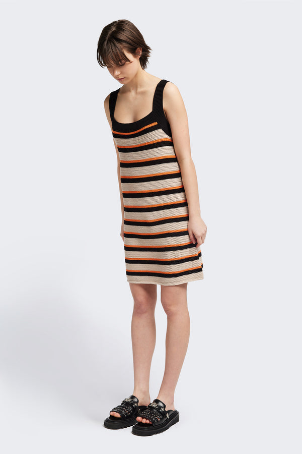 Front of The Temporal Dress in soft cotton yarn with shallow knit stripes in black, orange, and mushroom, featuring wide straps and a straight black neckline.