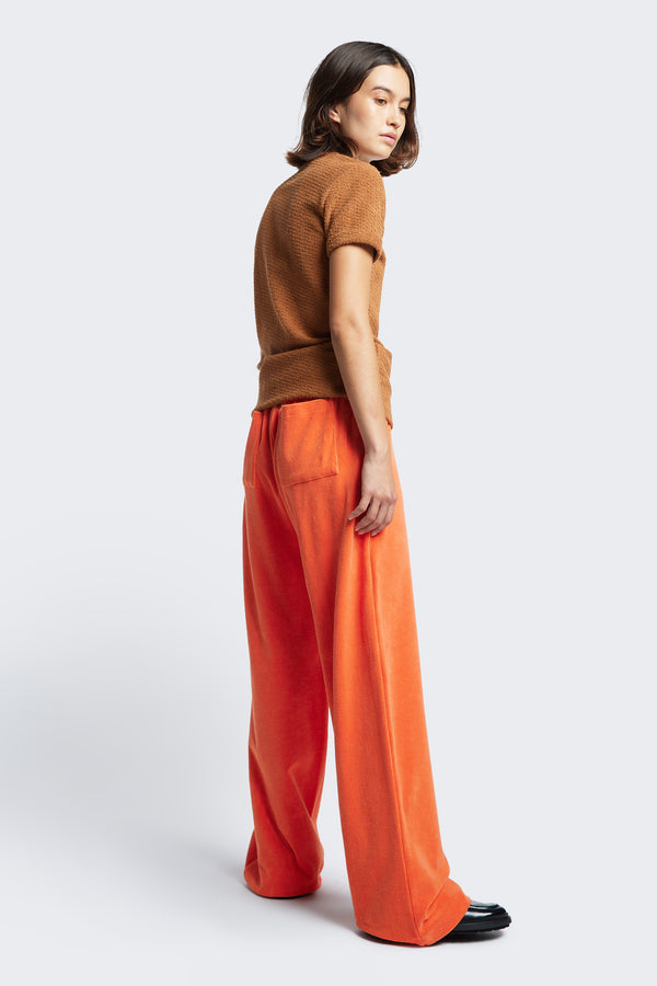 The back of the Prone Terry Towelling Track Pant Tangerine Orange, a straight leg track pant style with elasticated waist band and two back patch pockets.