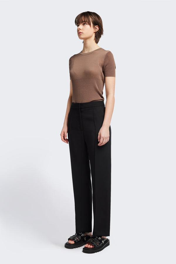 Front view of the Tranquillity Pant in black, a slim-fit stovepipe-style tailored pant with pin tuck detailing.