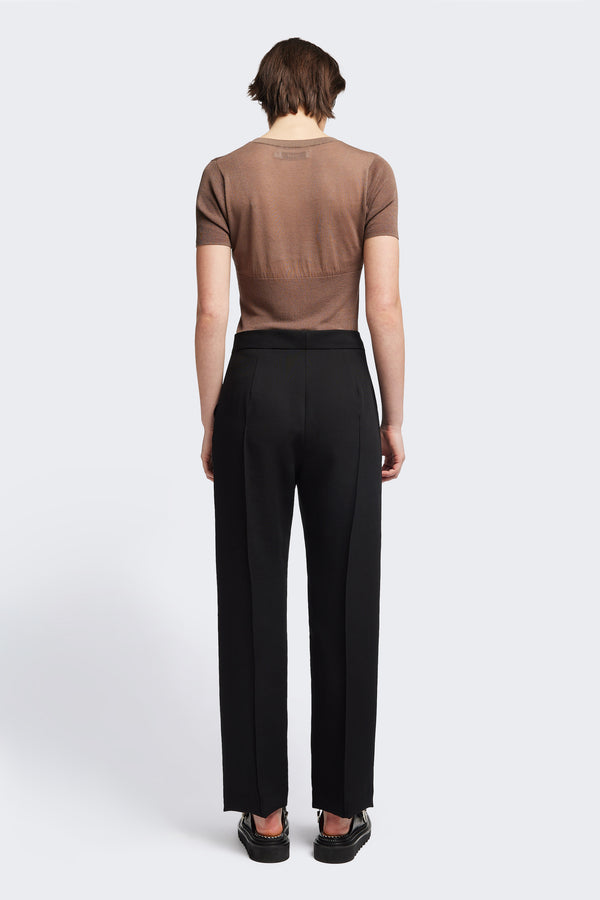 Back view of the Tranquillity Pant in black, a slim-fit stovepipe-style tailored pant with pin tuck detailing.