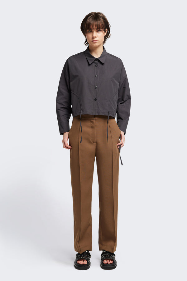 Front view of the Tranquillity Pant in brown, a slim-fit stovepipe-style tailored pant with pin tuck detailing.