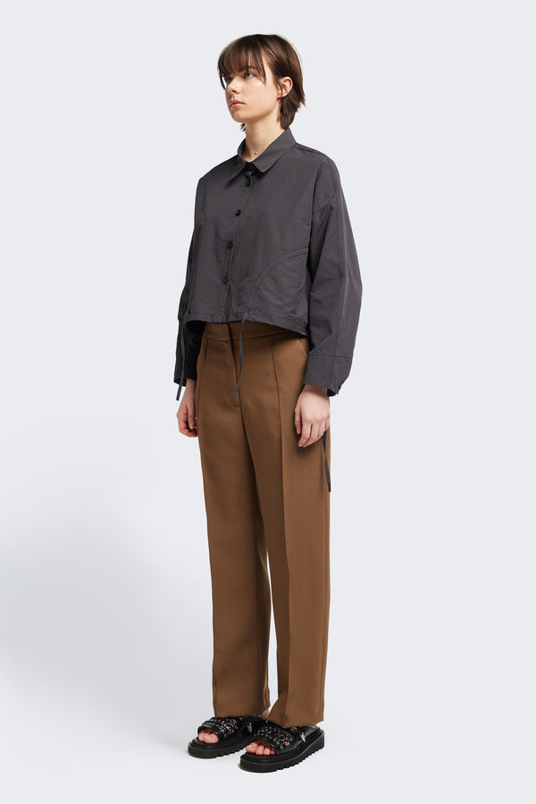 Front view of the Tranquillity Pant in brown, a slim-fit stovepipe-style tailored pant with pin tuck detailing.