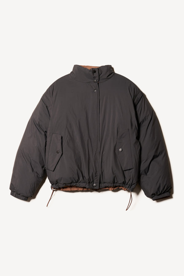 Flat Front of the Transform Puffa Jacket in black side, showcasing full sleeves, cropped length and high collar