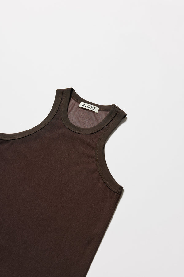Detail of ribbed binding at neckline and armholes of the brown Transformation Tank in sheer fabric with racerback neckline.