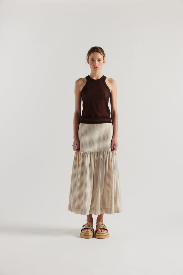 Front view on female model of the Brown Transformation Tank in sheer fabric with racerback neckline.