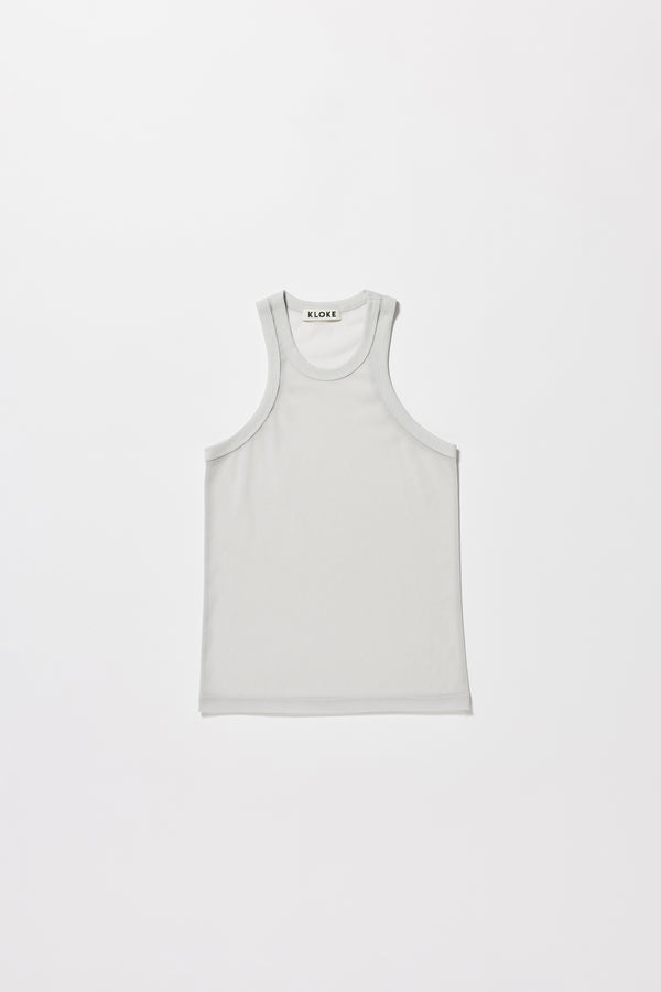 Flat front of the pale blue Transformation Tank in sheer fabric with racerback neckline.