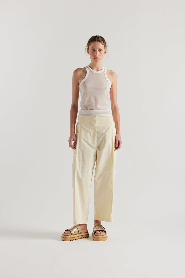 Front view on female model of the White Transformation Tank in sheer fabric with racerback neckline.