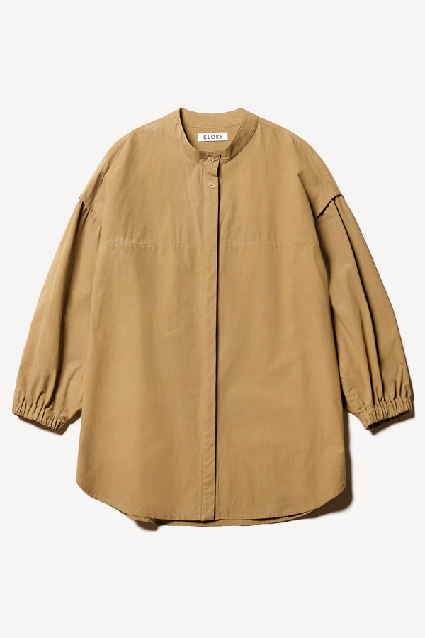 Flat front of the Transit Gathered Blouse in Dusty Olive a relaxed band collar shirt with dropped shoulders, pleated sleeves, and a curved hemline.