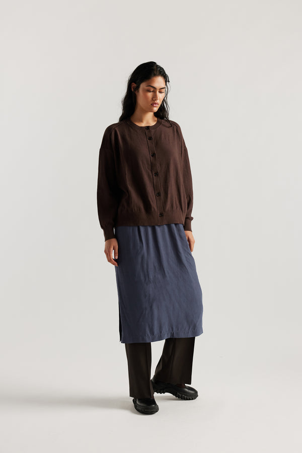 Front view on model of Mid-length slip skirt in Indigo soft viscose-rayon. Ft. elasticated gathered waist with self-tie pull and side split visible.