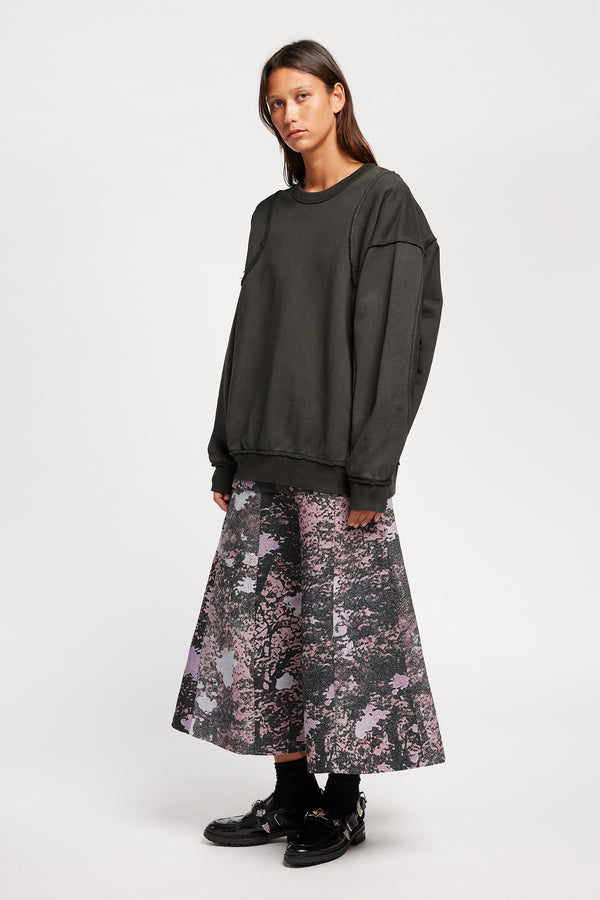 women - front of model wearing Unisex format oversized crew neck sweater in jet black  with clean panelled design and raw flat-locked seams, displayed from the front.