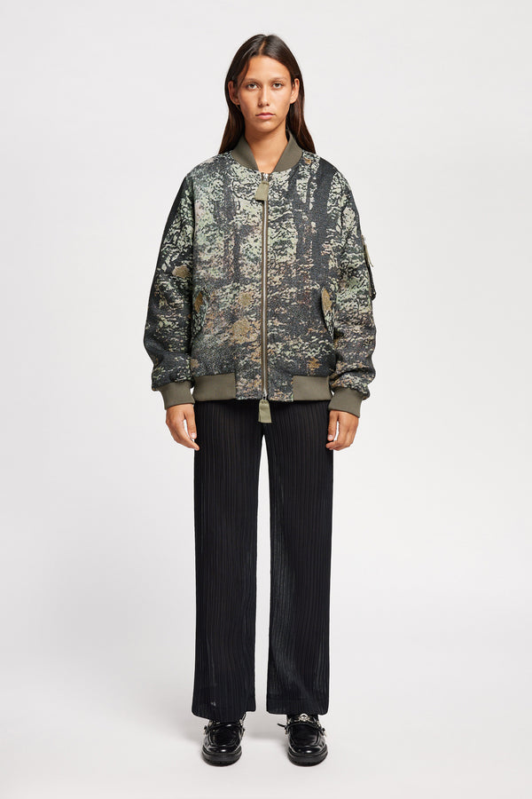 women - Front of Unisex bomber jacket in Green Print woven jacquard with real tree camouflage, featuring dropped shoulders, ribbed trims, and full-length front zip.