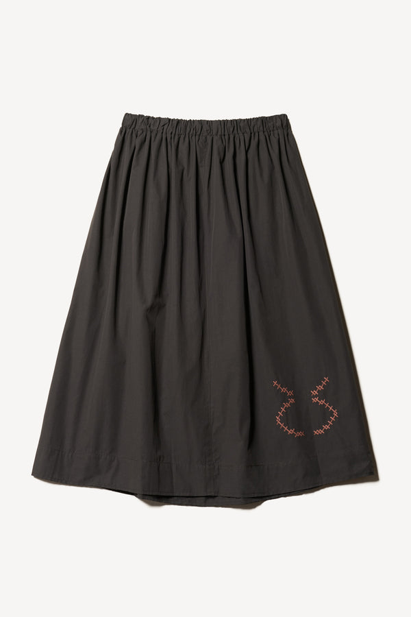 Flat back view of the Black Universe Embroidered Skirt showcasing Arecibo-inspired motifs.