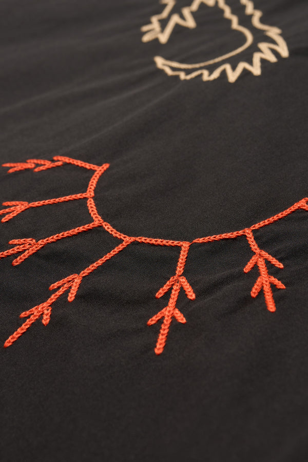 Close up embroidery details of the Black Universe Embroidered Skirt showcasing Arecibo-inspired motifs.